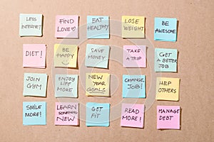 New year goals or resolutions - colorful sticky notes on a Notepad with coffee Cup