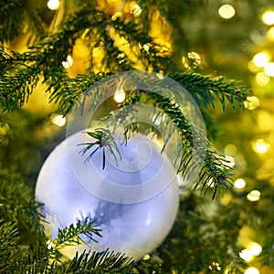 New year and green xmas tree decorations with white ball, close-up