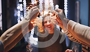New Year, happy and people with sparklers at party for celebration, collaboration and social gathering. Friends, hands