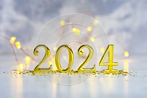 New Year holiday background. Golden numbers 2024 with bright glowing lights