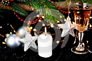 New Year holiday concept. New Year\'s decor - champagne glasses, New Year\'s toys, a Christmas tree with decorations, a candle is