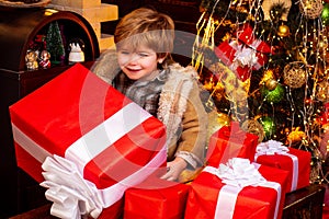 New year kids. Happy little boy child with present or gift box indoors. New year concept. Gift emotions. Winter