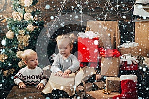 New year kids. kiddy. Child with a Christmas present on wooden background. Winter kids. Opening gifts on Christmas and