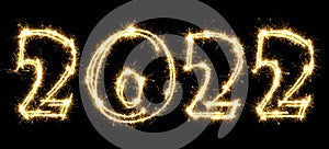 New Year 2022 made by sparkler . Number 2022 written sparkling sparklers . Isolated on a black background . Overlay template for