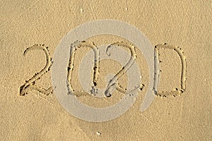 New year, number 2020 on beach sand