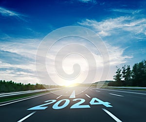 New year number 2024 and arrow sign on asphalt car road