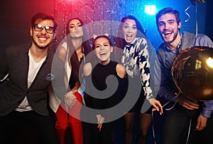 New year party, holidays, celebration, nightlife and people concept - Young people having fun dancing at a party