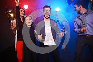 New year party, holidays, celebration, nightlife and people concept - Young people having fun dancing at a party