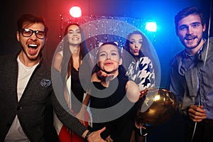 New year party, holidays, celebration, nightlife and people concept - Young people having fun dancing at a party