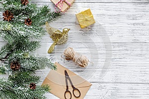 New year party preparation with gifts wrapping in boxes and envelopes on wooden background top veiw space for text