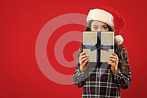 New year party. Santa claus kid. Christmas shopping. Present for Xmas. Childhood. Little girl child in santa red hat