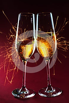 New Year party time with two champagne glasses and fireworks of