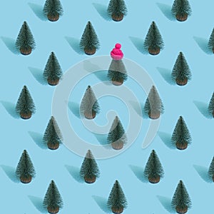 New Year pattern made with Christmas trees on bright light blue background. Minimal Christmas concept.