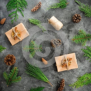 New Year pattern made of fir branches and gifts on dark background. Christmas composition. Flat lay