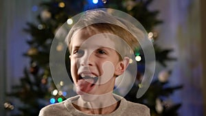 New Year. Portrait Of Boy With Blond Hair. Funny Boy Shows Funny Grimaces.