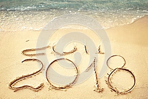 New Year 2018 replace 2017 on sea beach summer, New Year 2017 is coming concept. Closeup.