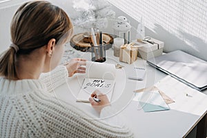 New year resolution, New goals, Start new year, planning and setting goals for the next year. Woman in white sweater