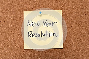 New Year resolution written on yellow sticky note pad
