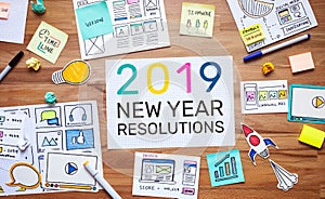 2019 new year resolutions with business digital marketing and paperwork sketch on wood table.analysis strategy concepts