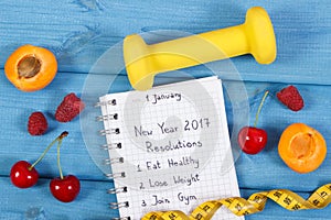 New year resolutions written in notebook on blue board