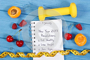 New year resolutions written in notebook on blue board