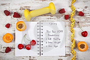 New year resolutions written in notebook on old board