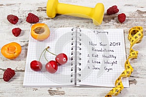 New year resolutions written in notebook on old board