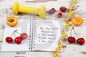 New year resolutions written in notebook on old board