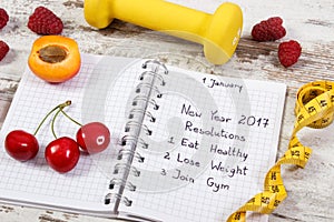 New year resolutions written in notebook on old board