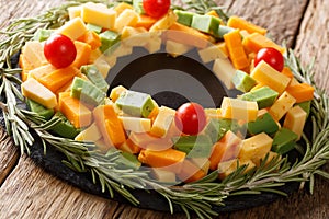 New Year`s appetizer of pesto cheese, cheddar, Mimolette with to