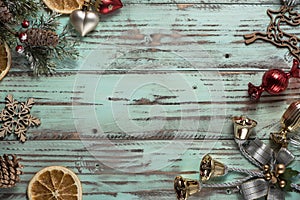 New year`s background on a light geen desk decorated with Christmas decoaration and candles. Bright colored Horizontal background