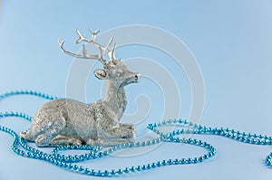 New Year\'s background. silver deer on a blue background