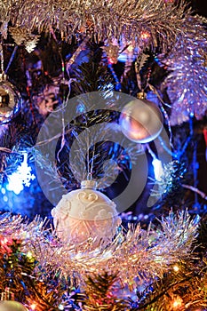 New Year's ball on a Christmas tree with shiny tinsel and garland