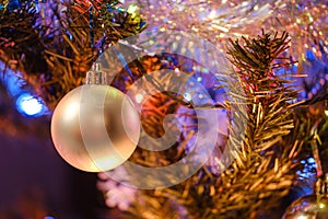New Year\'s ball on a Christmas tree with shiny tinsel and garland