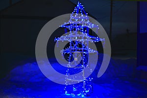 New Year`s card or background for greeting energy and electricians with Christmas. Garland on an electric pole