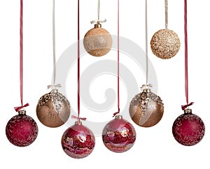 New Year\'s Christmas balls in brown burgundy gold color on a white background. Balloons hang on a ribbon with a bow.