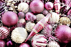 New Year's Christmas balls, tinsel and decorations close up. Decorations of golden, pink, lilac, purple, violet