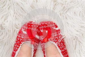 New Year`s, Christmas slippers for adults are dressed for the women. On white soft fur. Funny, funny, humorous, cozy,