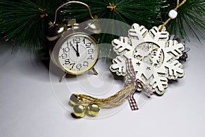 New Year`s clock, decorated with a wooden snowflake with sparkles. Christmas and New Year celebration concept