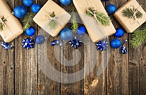 New Year`s composition. Christmas background from blue toys and gift boxes on a wooden background. Flat lay, top view, copy space