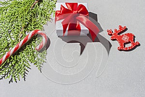 New Year`s composition. Christmas decorations on gray background with hard shadow and copy space