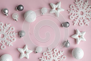 New Year's composition. Christmas pink and white decorations on a pastel pink background. Layout of a postcar