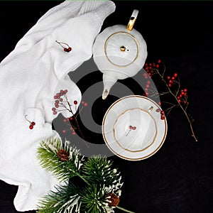 New Year's composition. New Year and Christmas. A spruce branch, a cup and a kettle on a red background