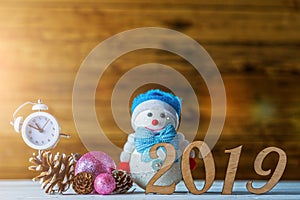 New Year& x27;s composition: clock, snowman, inscription 2019 and Christmas tree on a wooden background