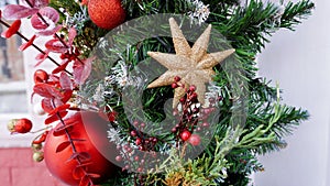 New Year`s composition of fir branches, Christmas tree toys in the form of stars, balls and golden twigs on makro street