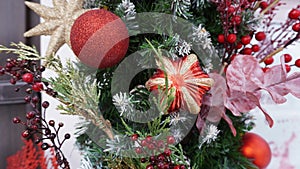 New Year`s composition of fir branches, Christmas tree toys in the form of stars, balls and golden twigs on makro street