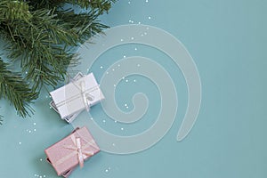 New Year`s composition. Gifts, fir branches, decorations on a mint background. Christmas, winter, new year concept. Flat lay, top
