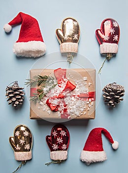 New Year`s concept, a box with a gift, Christmas-tree decorations are laid out on a blue background flat lay