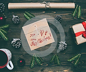 New Year`s concert, a wrapped gift, wrapping paper, Christmas tree branches and toys on a wooden rustic background