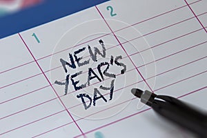 New Year`s Day on a calendar with with a highlighter. January 1